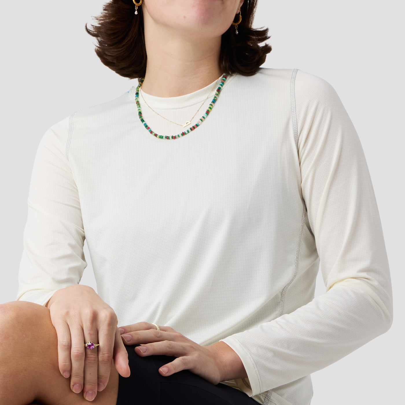Back view of Ornot Women's UV Trail Shirt in Oat, loose-fit long sleeve UV shirt for cycling, gravel, and adventure