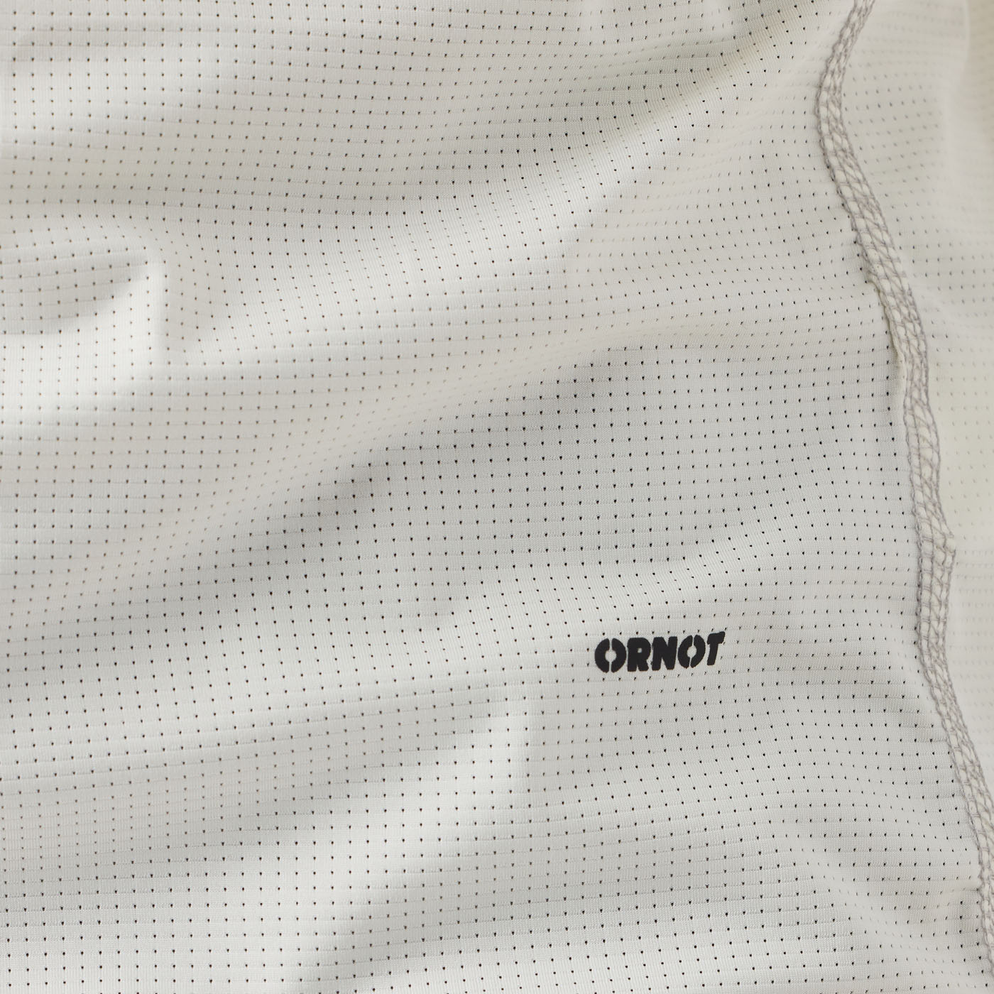 Detail of men's cream UV Trail Shirt fabric by Ornot, lightweight breathable material with UPF 30 sun protection